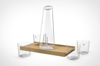 A carafe set with a large bottle and three glasses on a rectangular wooden tray. | © Zell am See-Kaprun & Studio F. A. Porsche